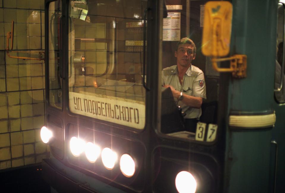 A train driver pulls into Biblioteka Imeni Lenina metro station in Moscow August 14, 2013. To step onto the Moscow metro is to step back in time and immerse yourself in a museum rich in architecture and history. Opened in 1935, it is an extravagant gallery of Communist design, featuring Soviet artworks, statues, chandeliers, stained glass and ceiling mosaics. Built under Stalin, the metro now transports 7 to 9 million people a day and costs 30 Rubles, around $1, for a single ride. Picture taken August 14, 2013. REUTERS/Lucy Nicholson (RUSSIA - Tags: TRANSPORT SOCIETY) ATTENTION EDITORS: PICTURE 15 OF 24 FOR PACKAGE 'RIDING THE MOSCOW METRO' SEARCH 'MOSCOW CHANDELIERS' FOR ALL IMAGES