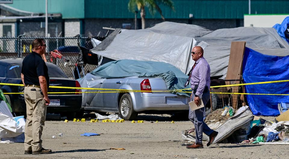 Members of the Tulare County Sheriff Department investigate an officer-involved shooting Tuesday, Aug. 16, 2022, near I Street and King Avenue.