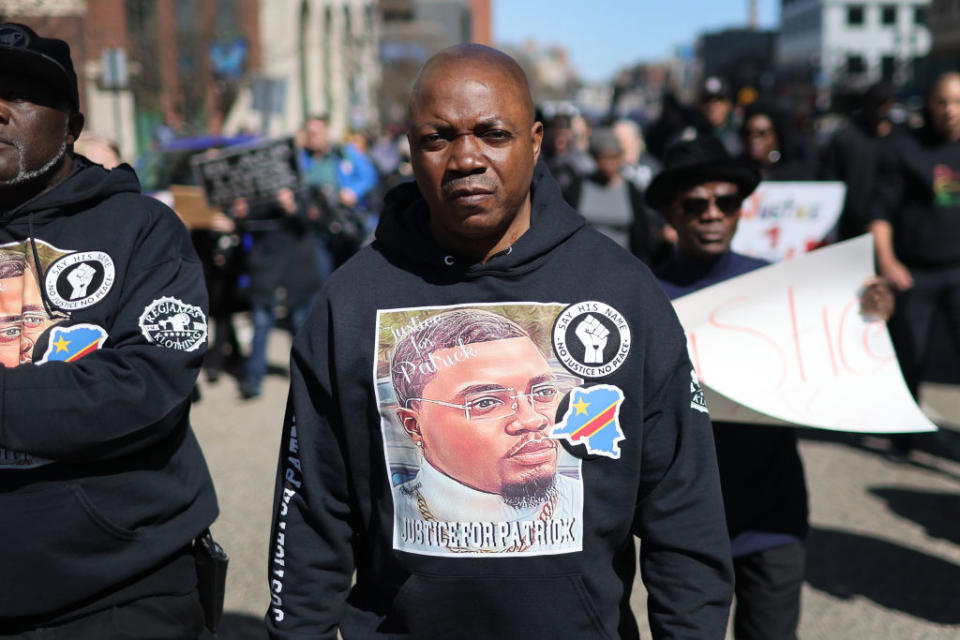 Peter Lyoya, the father of Patrick Lyoya, marches on April 21, 2022, to the Michigan state capital building in Lansing, Mich., where demonstrators called on the Grand Rapids police department to name, arrest, and prosecute the officer that shot his son.<span class="copyright">Scott Olson—Getty Images</span>