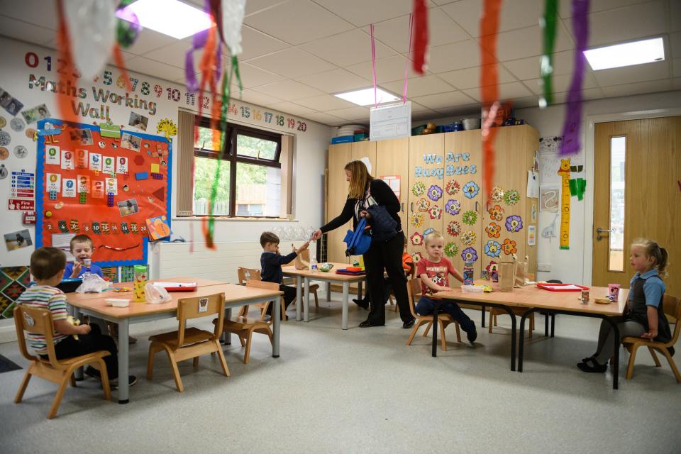 Nursery children have their lunch whilst sitting apart in order to minimise the risk of passing on Coronavirus at Willowpark Primary Academy in Oldham, north-west England on June 18, 2020, as primary schools to recommence education for Reception, Years 1 and Year 6 classes, alongside priority groups. (Photo by OLI SCARFF / AFP) (Photo by OLI SCARFF/AFP via Getty Images)