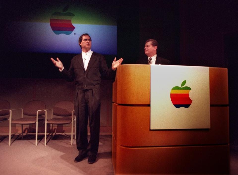 Former Apple CEO Gilbert R. Amelio (R) and Apple co-founder Steve Jobs on stage in 1996.