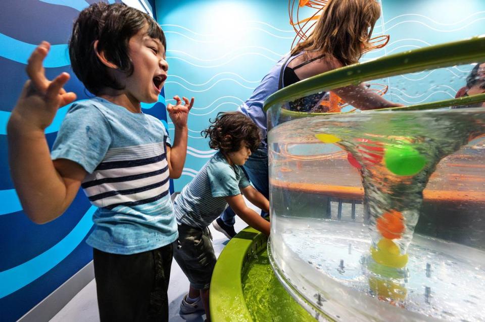 Konor Dominguez, 5, reacts after he throws colored balls into a vortex in the water lab at the Modesto Children’s Museum in Modesto, Calif., Thursday, Sept. 28, 2023.