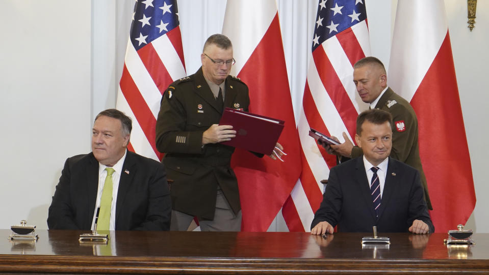 US Secretary of State Mike Pompeo, left, and Poland's Minister of Defence Mariusz Blaszczak sign the US-Poland Enhanced Defence Cooperation Agreement in the Presidential Palace in Warsaw, Poland, Saturday Aug. 15, 2020. Pompeo is on a five day visit to central Europe. (Janek Skarzynski/Pool via AP)