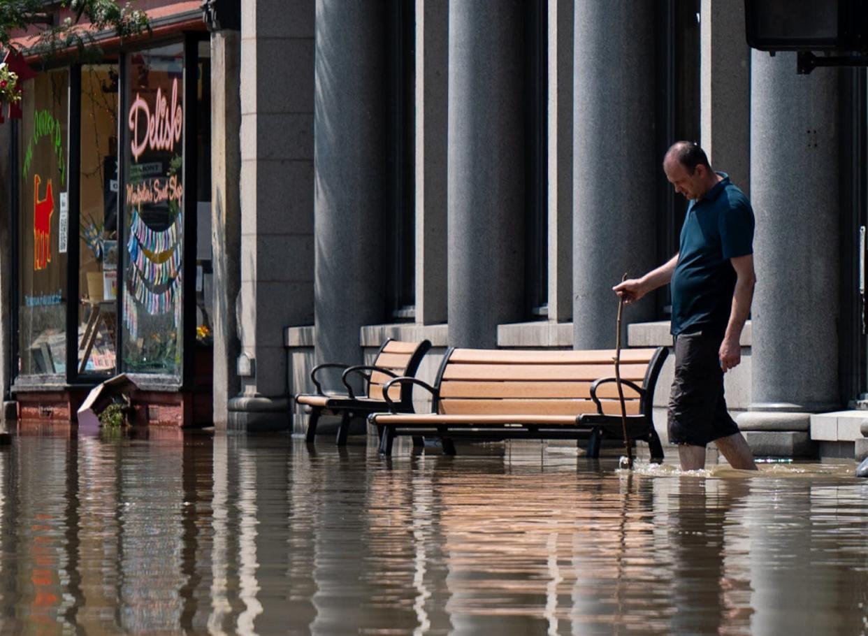 Flood water filled streets in downtown Montpelier, Vt., on July 11, 2023. <a href="https://www.gettyimages.com/detail/news-photo/person-walks-through-the-flooded-waters-of-main-street-on-news-photo/1524301769?adppopup=true" rel="nofollow noopener" target="_blank" data-ylk="slk:Kylie Cooper/Getty Images;elm:context_link;itc:0;sec:content-canvas" class="link ">Kylie Cooper/Getty Images</a>