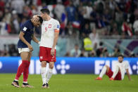 France's Kylian Mbappe, left, and Poland's Robert Lewandowski, right, speak after the World Cup round of 16 soccer match between France and Poland, at the Al Thumama Stadium in Doha, Qatar, Sunday, Dec. 4, 2022. (AP Photo/Natacha Pisarenko)