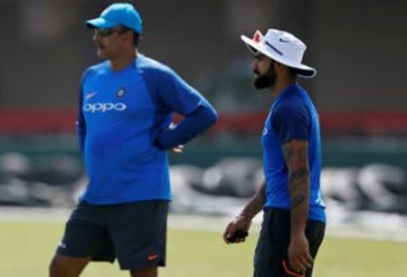 Cricket - Sri Lanka v India - India's Team Practice Session - Galle, Sri Lanka - July 25, 2017 - India's captain Virat Kohli walks past the team coach Ravi Shastri ahead of their first test match. REUTERS/Dinuka Liyanawatte