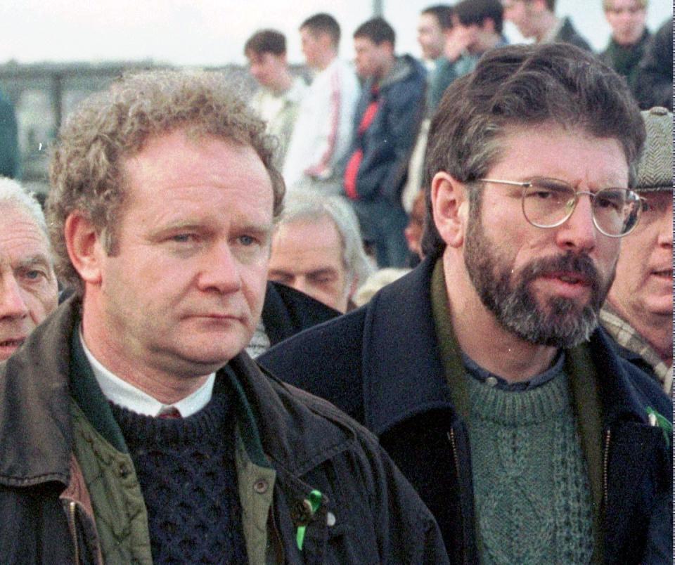 FILE - This is a Sunday, Feb. 1, 1998 file photo of Martin McGuinness, the Sinn Fein Chief Negotiator, left, and Sinn Fein's president Gerry Adams as they participate in the Bloody Sunday anniversary march in Londonderry, Northern Ireland. McGuinness, an IRA and Sinn Fein leader who became a minister of peacetime Northern Ireland, has died, according to UK media Tuesday, March 21, 2017 . (AP Photo/Paul McErlane, File)