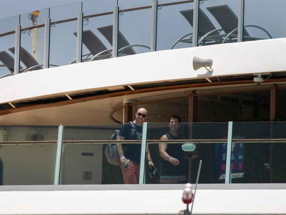 This image shows two passengers on a cruise ship deck.