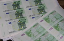 In this photo provided by Bulgaria's Interior Ministry on Tuesday, March 16, 2021, counterfeit money at a printing office in a university in Sofia. Bulgarian authorities say they have seized high-quality forged banknotes produced at a printing office in a university in the Bulgarian capital. In a joint operation with U.S. Secret Service, Bulgarian police detained two people and seized a printing machine and equipment for printing money, along with large amounts of counterfeit U.S. dollar and euro notes. (AP Photo/Bulgarian Interior Ministry)