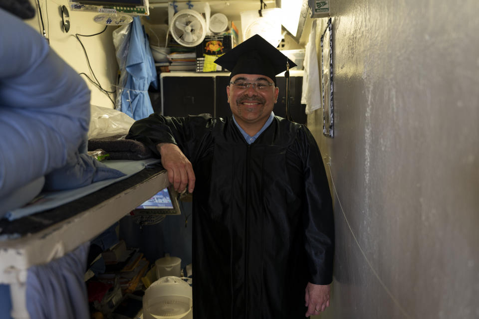 Gabriel Bonilla, who earned a bachelor's degree in communications through the Transforming Outcomes Project at Sacramento State (TOPSS), stands for a portrait in his cell after a graduation ceremony at Folsom State Prison in Folsom, Calif., Thursday, May 25, 2023. (AP Photo/Jae C. Hong)