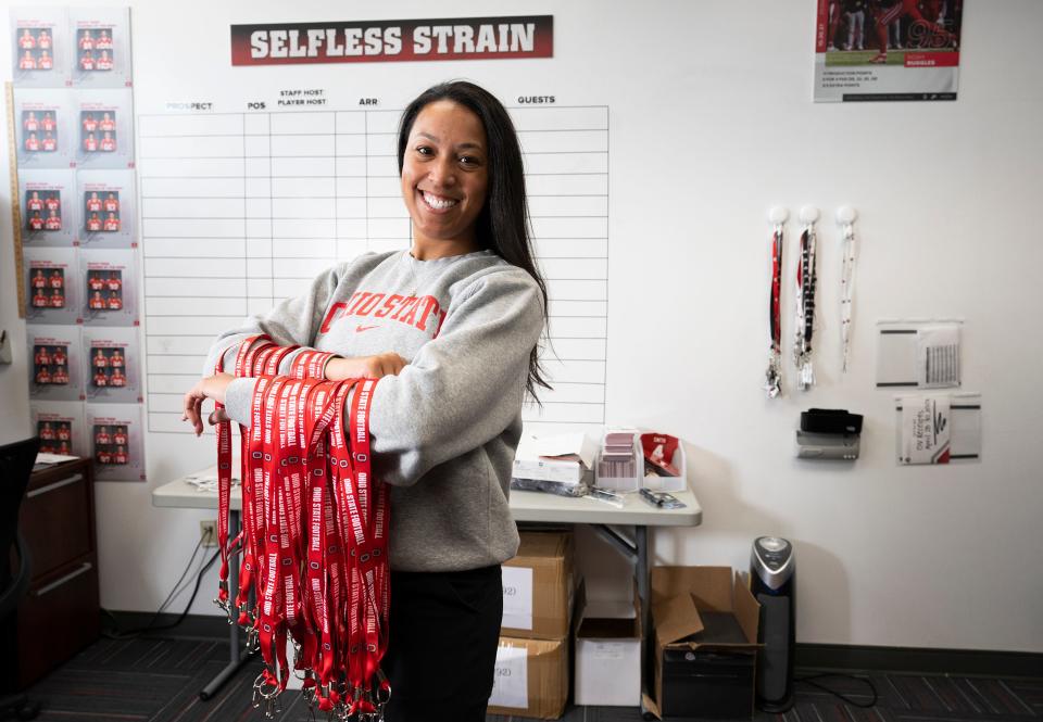 Erin Dunston, Ohio State football's director of on-campus recruiting, holds lanyards in her office.