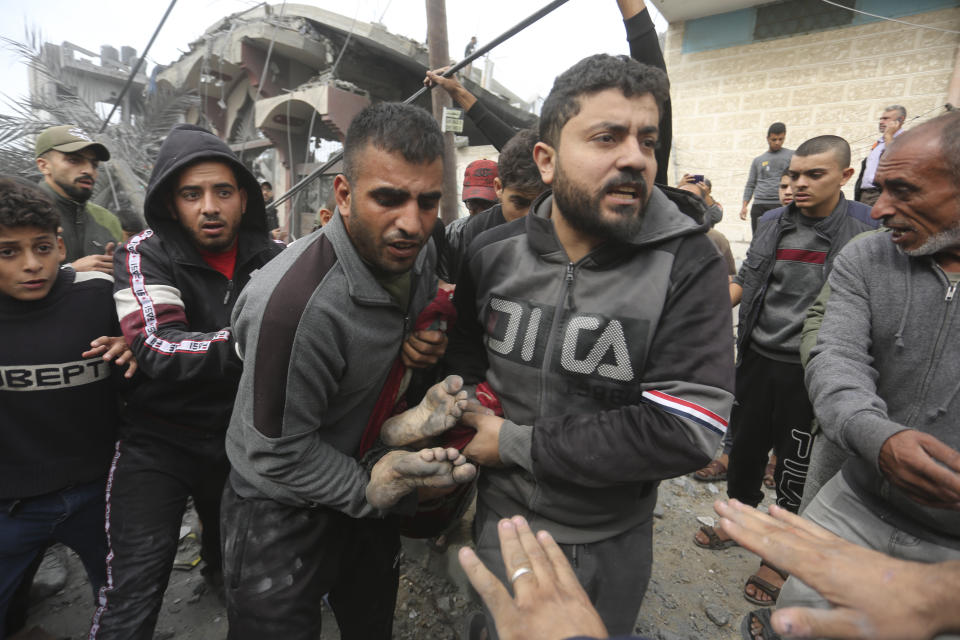 Palestinians evacuate survivors of the Israeli bombing in Rafah, Gaza Strip, Wednesday, Nov. 22, 2023. (AP Photo/Hatem Ali)