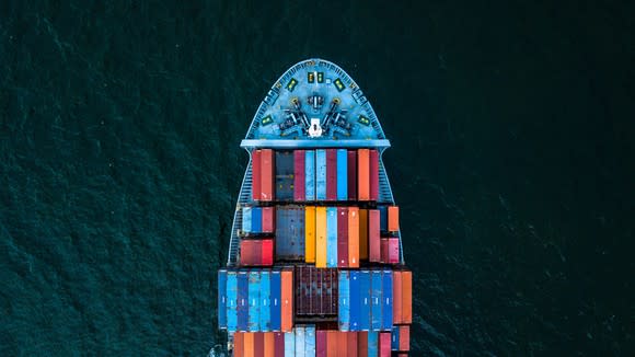 Overhead shot of shipping containers on a ship at port.