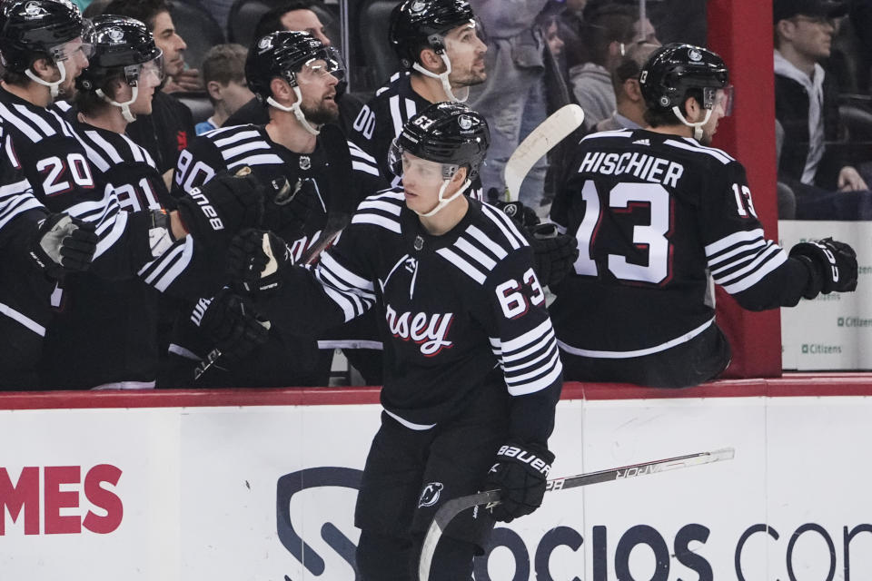 New Jersey Devils' Jesper Bratt (63) celebrates with teammates after scoring a goal during the first period of an NHL hockey game against the Montreal Canadiens Tuesday, Feb. 21, 2023, in Newark, N.J. (AP Photo/Frank Franklin II)