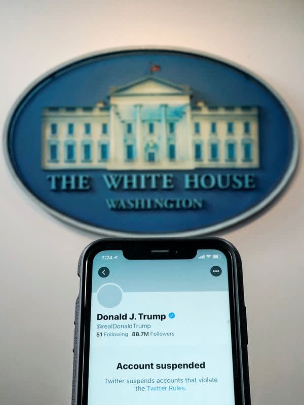 FILE PHOTO: A photo illustration shows the suspended Twitter account of U.S. President Donald Trump on a smartphone at the White House briefing room in Washington