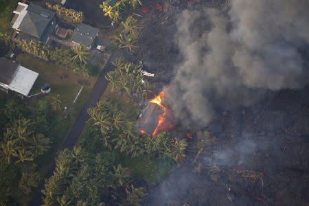 Lava destroys homes in the Kapoho area, east of Pahoa, during ongoing eruptions of the Kilauea Volcano in Hawaii, U.S., June 5, 2018. REUTERS/Terray Sylvester