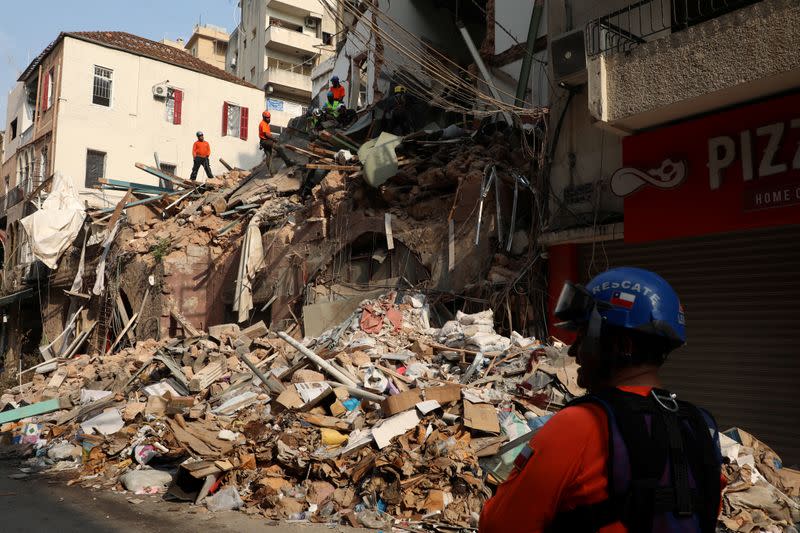 A rescue team searches through rubble of damaged buildings due to the massive explosion at Beirut's port area, in Beirut