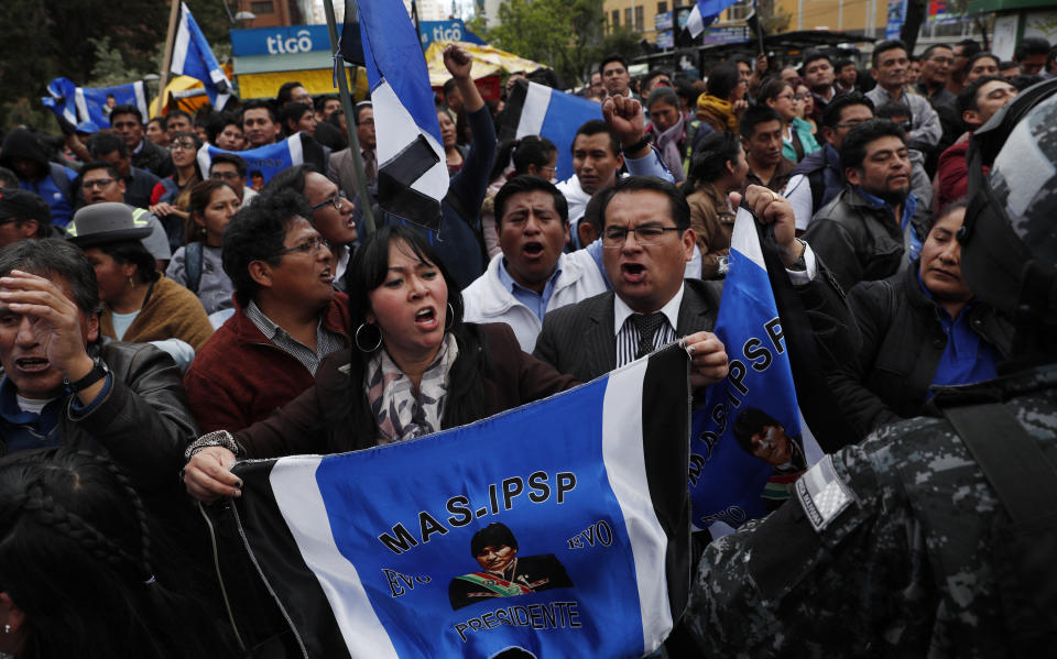 Supporters of Bolivian President Evo Morales, who is running for a fourth term, rally outside the Supreme Electoral Court where election ballots are being counted in La Paz, Bolivia, Monday, Oct. 21, 2019. A sudden halt in release of presidential election returns led to confusion and protests in Bolivia on Monday as opponents suggested officials were trying to help Morales avoid a risky runoff. (AP Photo/Juan Karita)