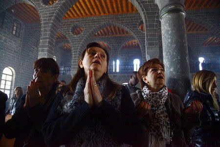 Armenian Christian women pray during an Easter mass at Surp Giragos church in Diyarbakir, in the Kurdish-dominated southeastern Turkey, April 5, 2015. REUTERS/Sertac Kayar