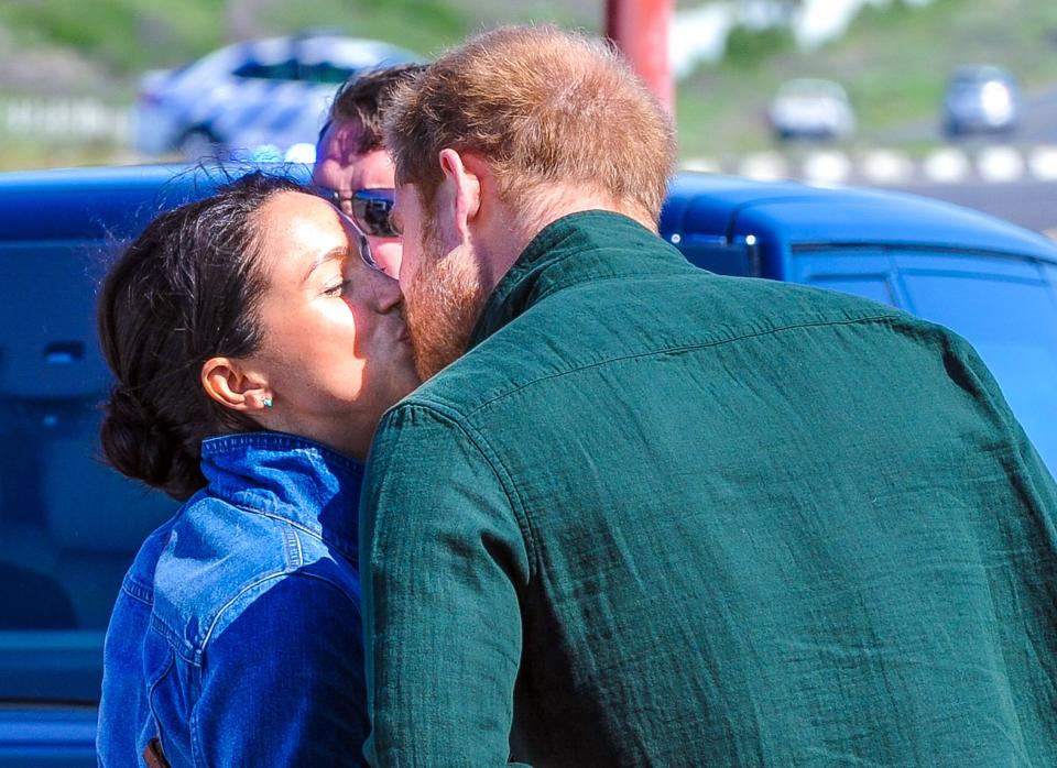 The couple shared a <a href="https://people.com/royals/meghan-markle-prince-harry-kiss-goodbye-royal-tour-africa/" rel="nofollow noopener" target="_blank" data-ylk="slk:rare royal tour kiss;elm:context_link;itc:0;sec:content-canvas" class="link ">rare royal tour kiss</a> when Meghan left to take care of their son, 4-month-old Archie. 