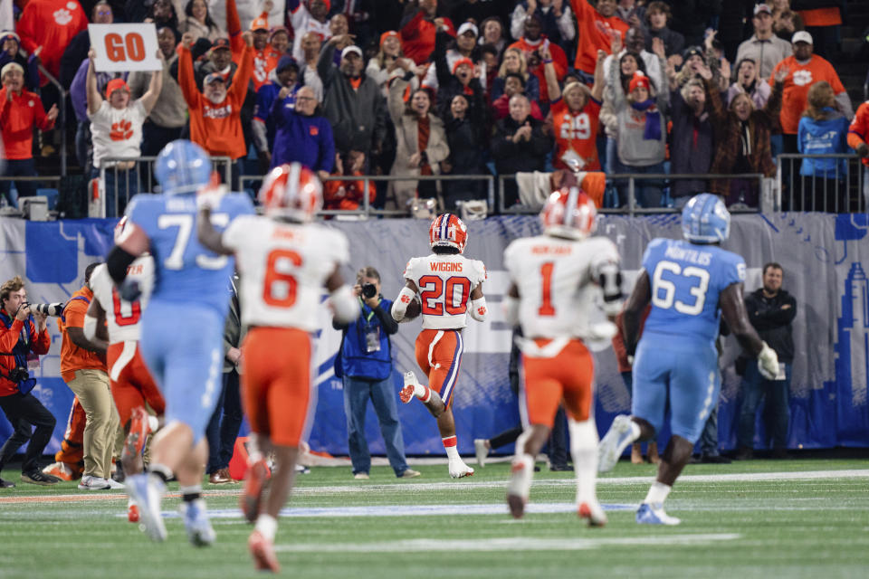 Clemson cornerback Nate Wiggins (20) returns an interception for a touchdown in the second half during the Atlantic Coast Conference championship NCAA college football game against North Carolina on Saturday, Dec. 3, 2022, in Charlotte, N.C. (AP Photo/Jacob Kupferman)
