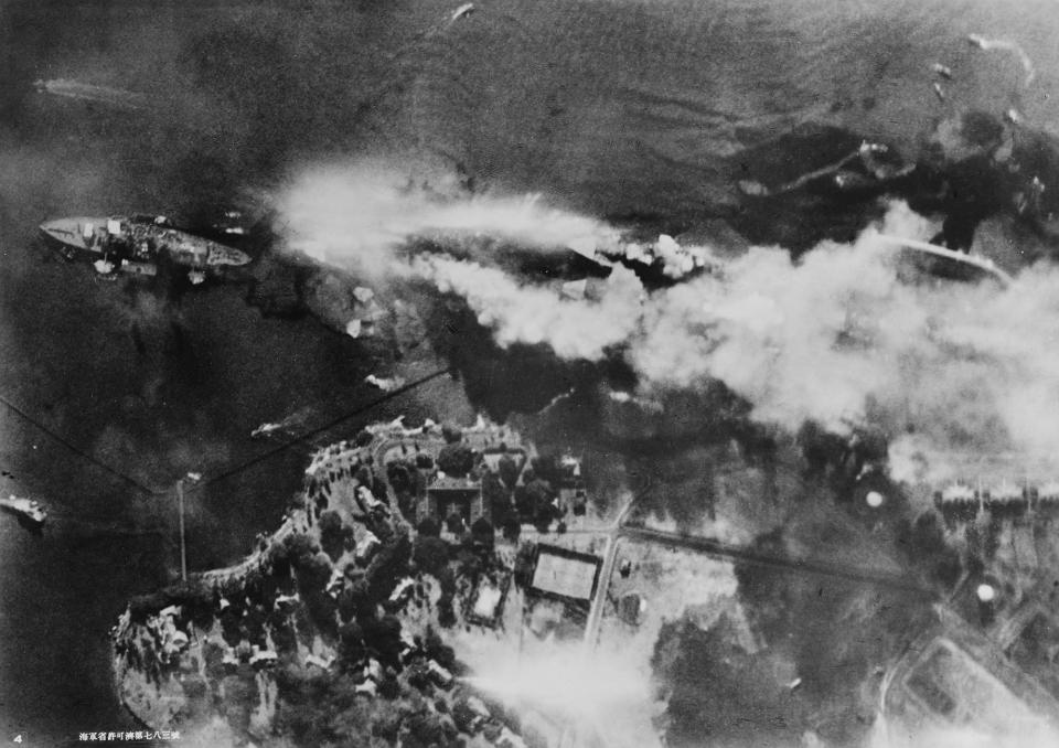 <p>The battleship USS Arizona burns on Battleship Row, beside Ford Island, in an aerial photo taken from a Japanese aircraft during the attack on Pearl Harbor on Dec. 7, 1941. Ships seen are, from left, USS Nevada, USS Arizona with USS Vestal moored outboard, USS Tennessee with USS West Virginia moored outboard, and USS Maryland with USS Oklahoma capsized alongside. (U.S. Naval History and Heritage Command/Handout via Reuters) </p>