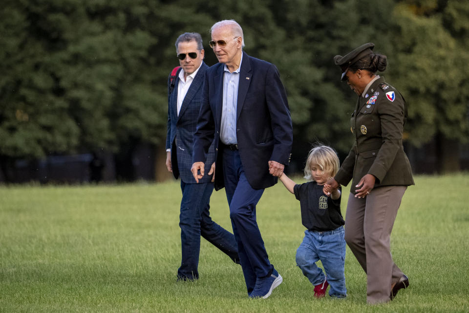 President Joe Biden walks with his grandson Beau Biden and his son Hunter Biden, left, from Marine One upon arrival at Fort McNair, Sunday, June 25, 2023, in Washington. The Biden's are returning from Camp David. (AP Photo/Andrew Harnik)
