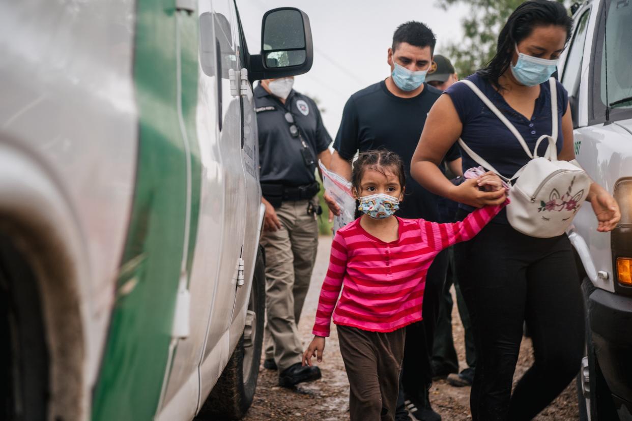 An immigrant family seeking asylum prepare to be taken to a border patrol processing facility after crossing into the US on 16 June, 2021 in La Joya, Texas. US Attorney General Merrick Garland has reversed two Trump-era asylum decisions. (Getty Images)