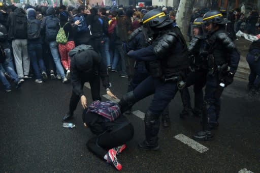 Riot police clash with demonstrators in Paris during a nationwide day of protest by French public sector employees against proposed government reforms. Around 139,000 people demonstrated nationwide, according to the interior ministry