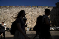 Tourists visit the Old City of Jerusalem, Wednesday, June 15, 2022. The summer of 2022 can feel as if the coronavirus pandemic is really over — mask rules and testing requirements are lifting in many countries, including the United States. Full recoveries are generally not expected until at least 2024. (AP Photo/Maya Alleruzzo)