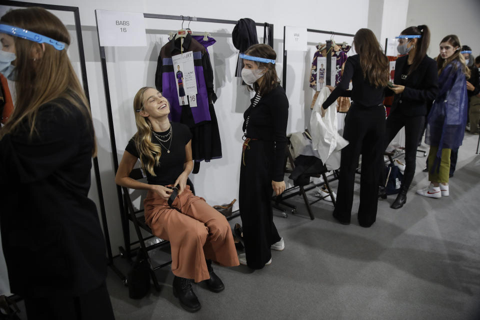 Models get ready in the backstage prior to the start of the Shi.RT women's Spring-Summer 2021 fashion show, in Milan, Italy, Sunday, Sept. 27, 2020. (AP Photo/Luca Bruno).