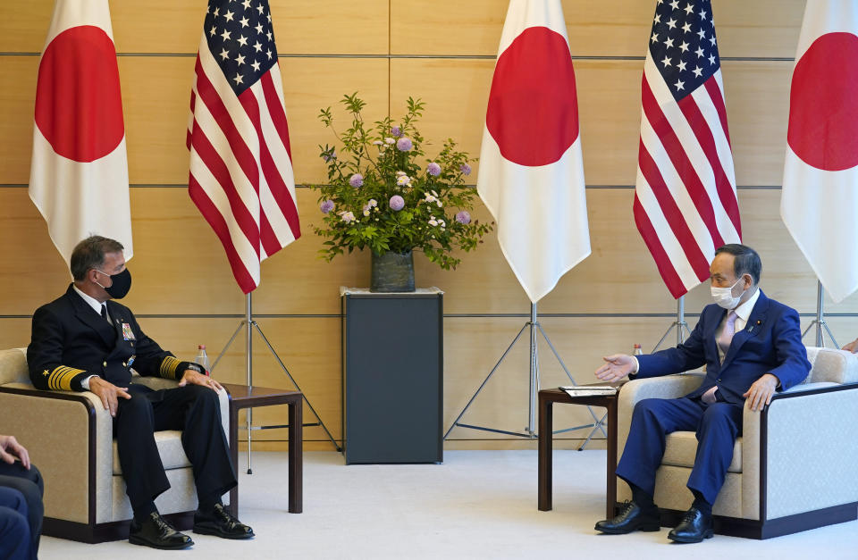 Admiral John C. Aquilino, left, Commander of the United States Indo-Pacific Command, listens to Japanese Prime Minister Yoshihide Suga at the start of their meeting at the prime minister's official residence in Tokyo, Japan, Tuesday, June 1, 2021. (Franck Robichon/Pool Photo via AP)