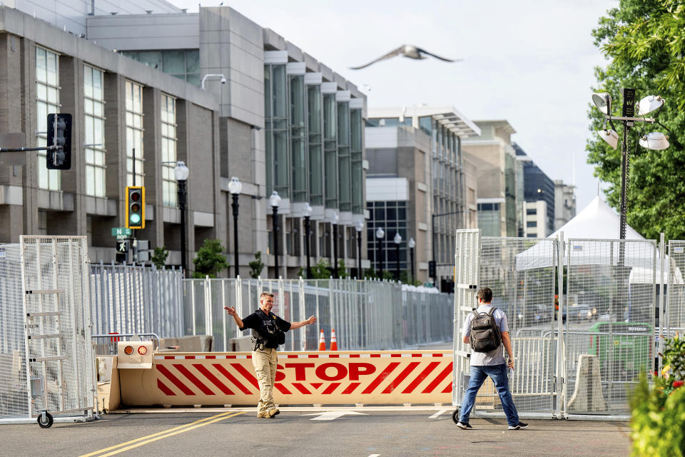 A U.S. Secret Service agent directs a pedestrian around a security perimeter at the NATO summit, in Washington, Wednesday, July 10, 2024. (AP Photo/Noah Berger)