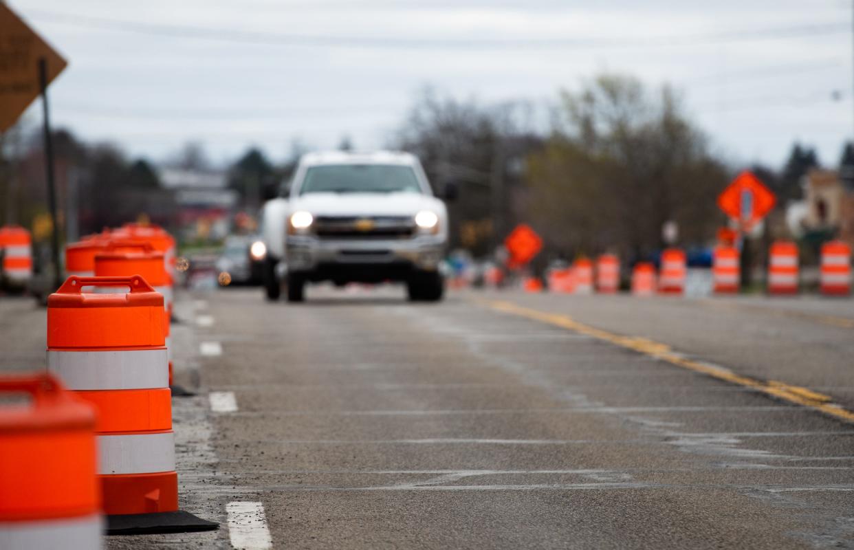 Orange barrels reroute traffic along East Grand River Avenue near Nakoma Drive in Meridian Township due to construction, Wednesday, April 27, 2022.