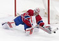 Montreal Canadiens goaltender Cayden Primeau makes a save against the Columbus Blue Jackets during the third period of an NHL hockey game Tuesday, March 12, 2024, in Montreal. (Christinne Muschi/The Canadian Press via AP)
