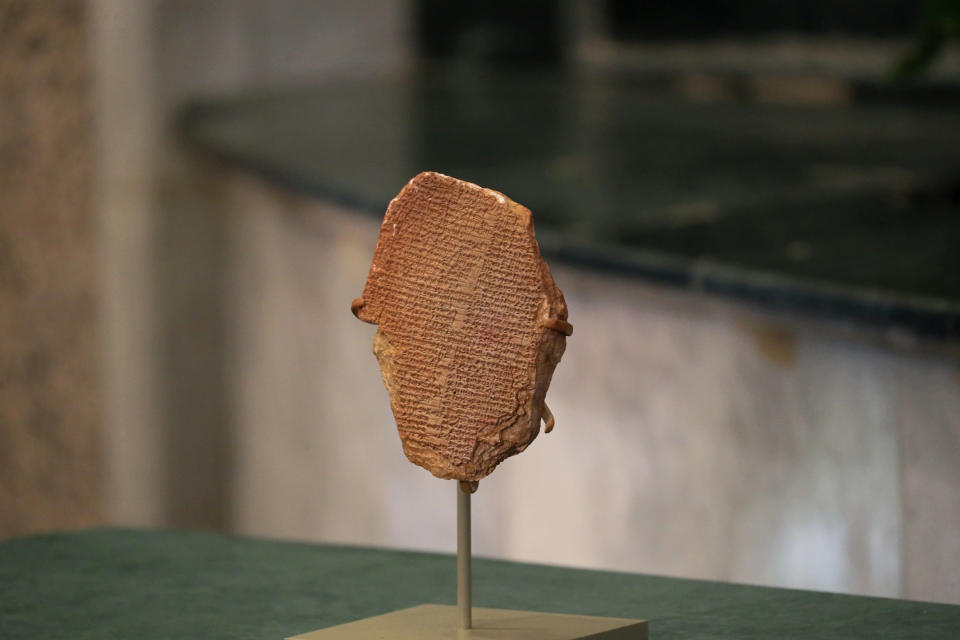 A recovered clay tablet is displayed at the Ministry of Foreign Affairs, Baghdad, Iraq, Tuesday, Dec. 7, 2021. A 3,500-year-old clay tablet bearing a portion of the Epic of Gilgamesh that was looted from an Iraqi museum 30 years ago was formally returned to Iraq Monday. (AP Photo/Khalid Mohammed).