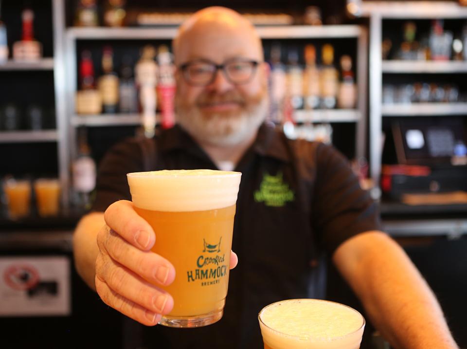 Larry Horwitz, with Crooked Hammock Brewery, holds a glass of Joint Collaboration IPA. The beer is made with terpenes. While it gives the beer a marijuana flavor, it won't get you high.