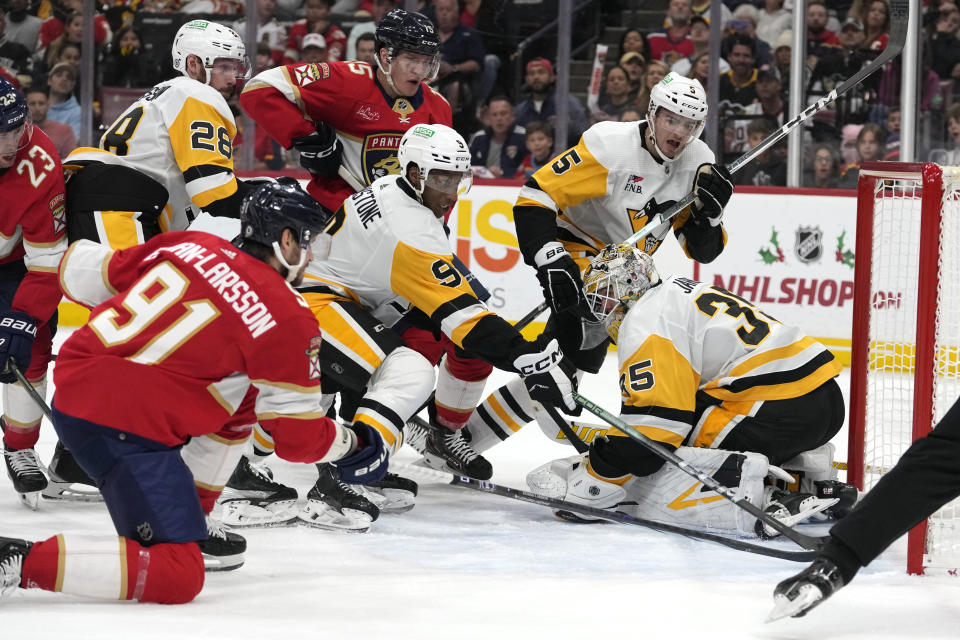 Florida Panthers defenseman Oliver Ekman-Larsson (91) scores a goal against Pittsburgh Penguins goaltender Tristan Jarry (35) during the second period of an NHL hockey game, Friday, Dec. 8, 2023, in Sunrise, Fla. (AP Photo/Lynne Sladky)