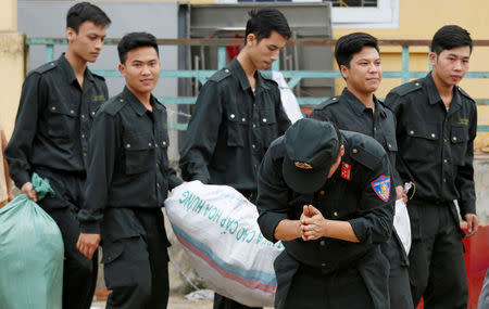 A police officer thanks villagers after the hostages, who were originally held by the villagers in a land dispute, were released in Dong Tam, outside Hanoi, Vietnam April 22, 2017. REUTERS/Kham