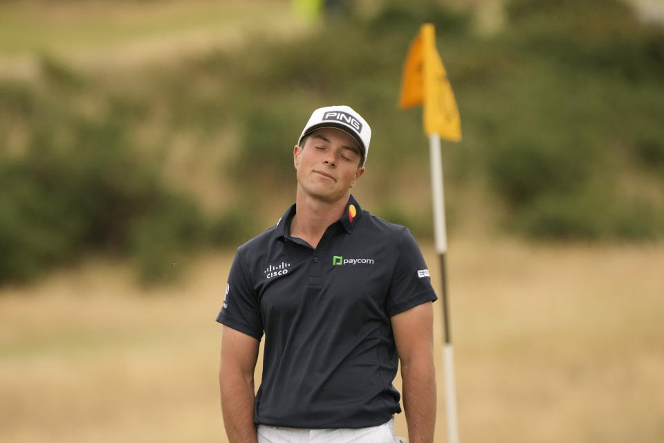 Viktor Hovland, of Norway, reacts after missing a long putt on the 11th green during the third round of the British Open golf championship on the Old Course at St. Andrews, Scotland, Saturday July 16, 2022. (AP Photo/Gerald Herbert)