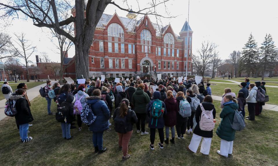 Students gather in front of Main Hall at St. Norbert College on Wednesday to protest recently announced layoffs of college faculty.