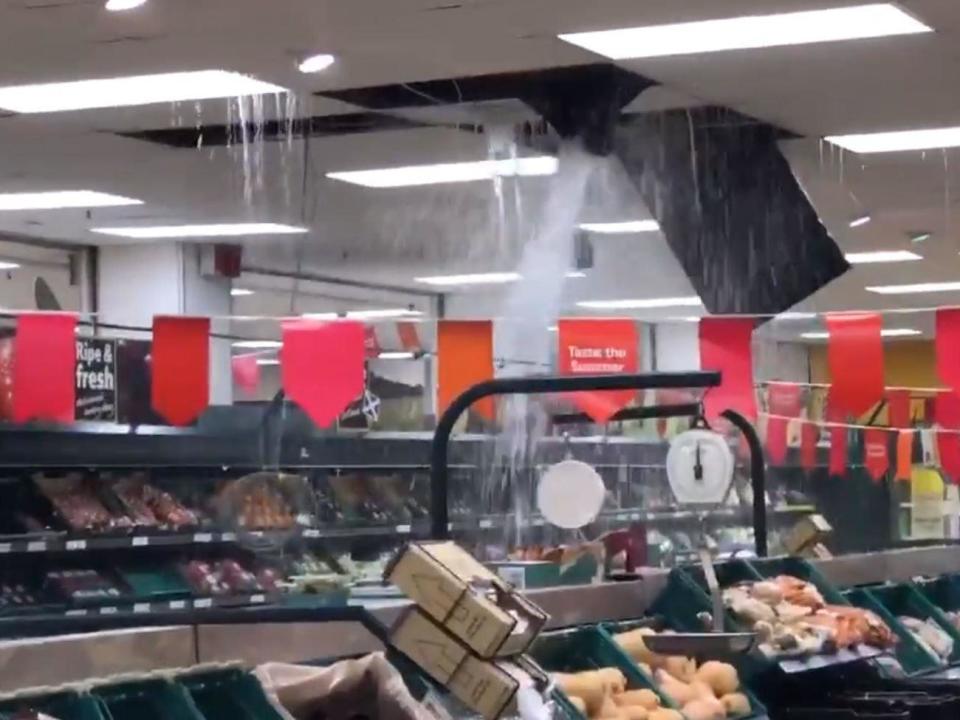 The roof of a Tesco supermarket collapsed and 14 people were rescued by boat from a flood-stricken rugby club as torrential downpours hit the UK.Footage filmed by a customer showed ceiling panels falling off as rainwater poured into the fruit and vegetable aisles of the shop in Stirling, central Scotland.The supermarket was evacuated on Monday evening and remained shut the following day.Elsewhere in the city, firefighters rescued 14 people from Stirling County Rugby Club after they were stranded by flash flooding.A spokeswoman for Stirling fire station said a water rescue team was sent to the club at 8.45pm and everyone was “fit and well” after being helped to safety by boat.Flooding also forced the closure of several roads and schools in the city on Tuesday.Hollie King, 19, shared a video online which showed water gushing down Baker Street in Stirling's town centre as she remained trapped in a friend's flat."I nearly got hit by a bin because they were all flying down the hill," she said. "One of the men that works in an ice-cream shop across the road was chasing his tables and mop and plants down the street because they just got washed away.In Edinburgh, torrential rain on Monday caused severe floods and long delays to many travel routes in the west of Scotland’s capital. Several roads were shut and tram services were suspended.Flooding and train cancellations also hit parts of England at the start of a week in which temperatures are expected to rise above 30C.Almost half a month's worth of rain fell in just a few hours in some areas on Tuesday morning, with Kent and Sussex soaked by the heaviest downpours.Localised flooding was reported across the Southeast as commuters set off to work.Rail operator Southern reported that all lines from Brighton through to Haywards Heath were temporarily blocked due to the heavy rain and flooding on the tracks, with some passengers delayed by more than an hour.Coastal areas were the worst hit by downpours, but some 8mm of rain in London also caused minor flooding on some roads.The thunderstorms were fuelled and carried to UK shores by a plume of warm air coming in from continental Europe, which is now baking in a heatwave that could bring record-breaking temperatures to France, Spain and Belgium.Peak temperatures across much of England later this week are predicted to be well above 20C, with the forecast for Glastonbury Festival looking dry and sunny.Public Health England warned the heat could pose health risks to the elderly and people with underlying conditions.