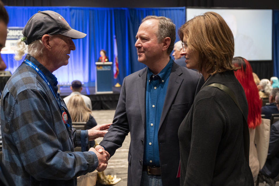 Rep. Adam Schiff, who is running for U.S. Senate, shakes hands with supporter Michael Nye while standing with his wife, Eve, at the California Democratic Party fall endorsing convention, Friday, Nov. 17, 2023, at SAFE Credit Union Convention Center in Sacramento. (Lezlie Sterling/The Sacramento Bee via AP)