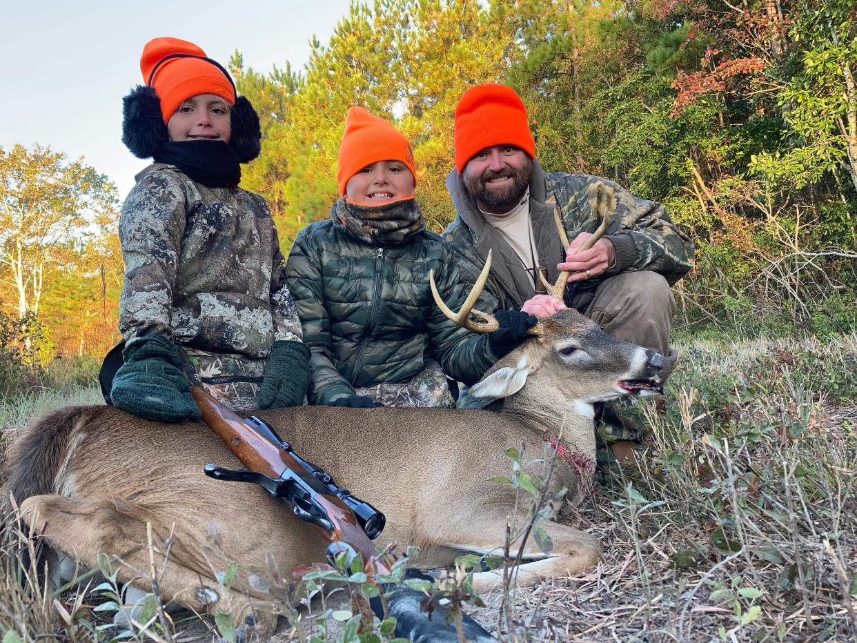 Ian Nance and his children show off Harrison Nance's first whitetail buck.