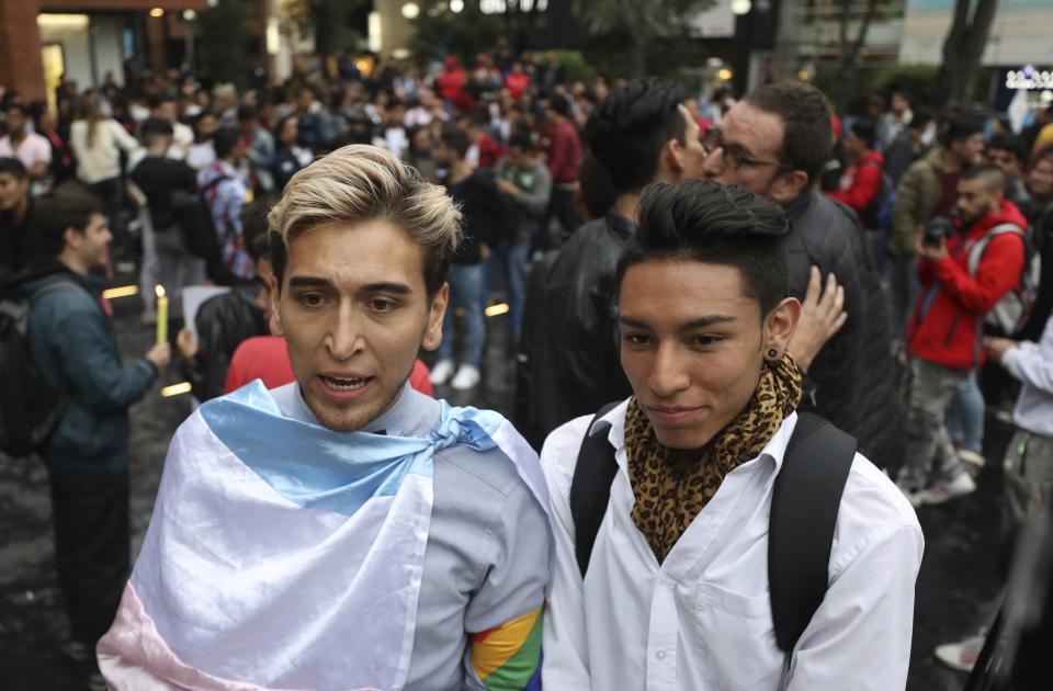 Esteban Carrillo, 24, left, and Nicolas Tellez, 19, talk to the press during a "kiss-a-thon," a form of protest for LGBT rights in Bogota, Colombia, Wednesday, April 17, 2019. The event was held at the same Andino shopping mall where days ago the two were harassed by a customer who lured police into fining them for "exhibitionism." (AP Photo/Fernando Vergara)