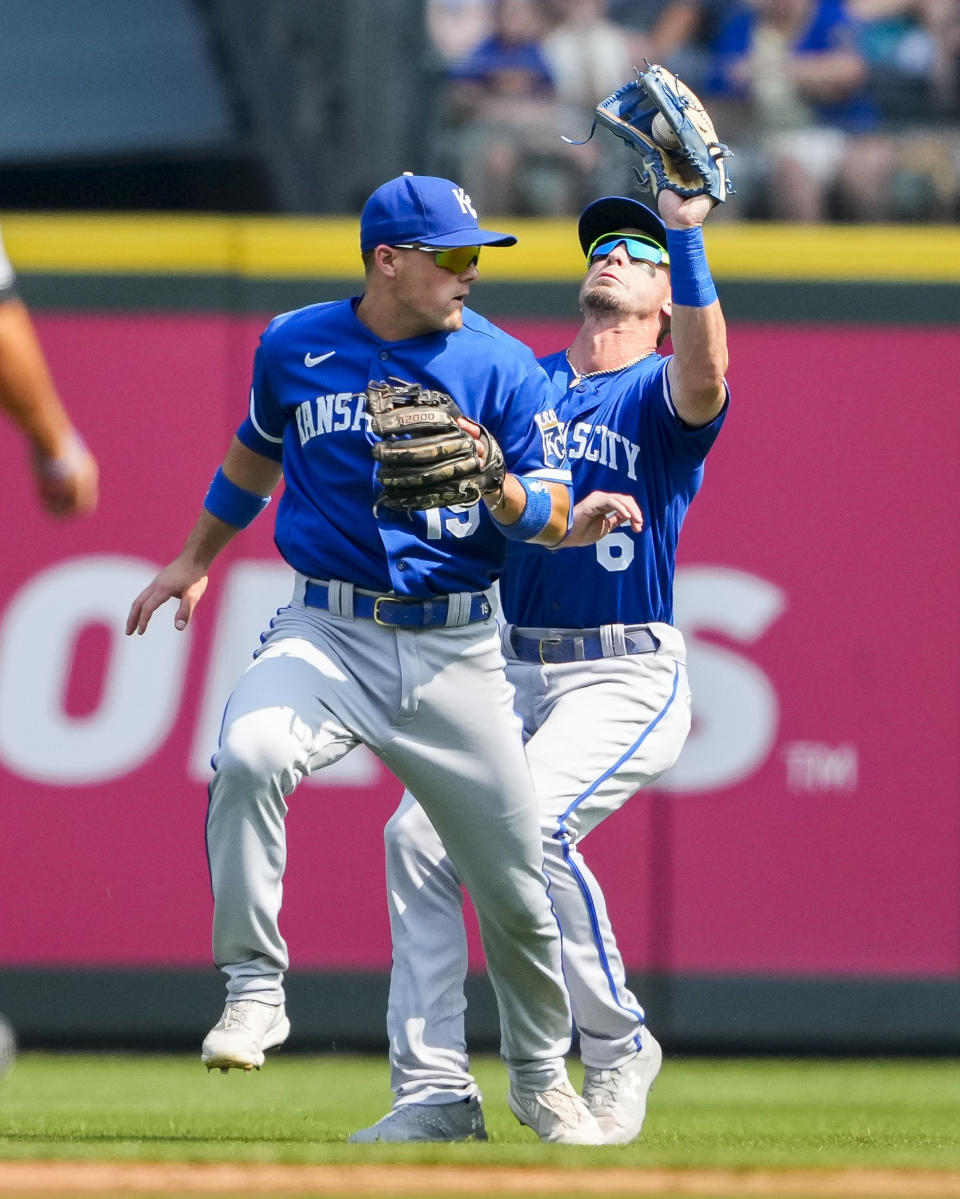 Kansas City Royals right fielder Drew Waters (6) holds on to the popout from Seattle Mariners' Julio Rodriguez as he collides with second baseman Michael Massey (19) during the first inning of a baseball game Saturday, Aug. 26, 2023, in Seattle. (AP Photo/Lindsey Wasson)