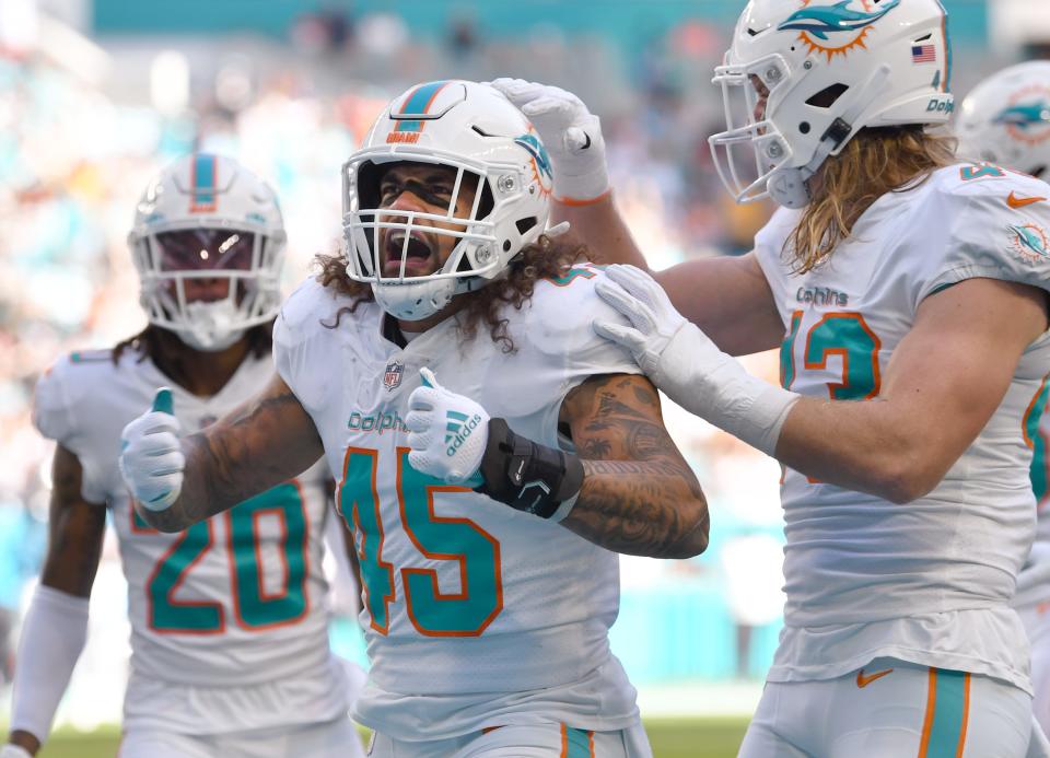 Dolphins outside linebacker Duke Riley celebrates blocking a punt , which resulted in a touchdown, in the first quarter of Sunday's win over the Panthers.