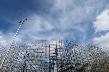 Workers are pictured at the construction site of the beach volleyball venue on Copacabana beach in Rio de Janeiro, Brazil, June 9, 2016. REUTERS/Sergio Moraes