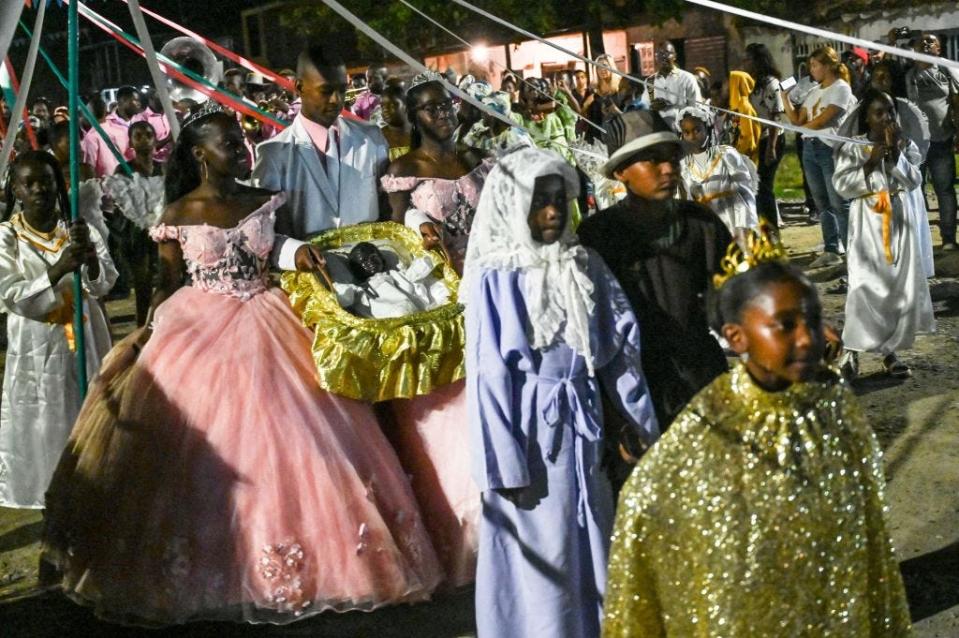 Afro-Colombians hold a basket with "Nino Dios" (God Child) inside in Quinamayo, department of Valle del Cauca, Colombia, on February 18, 2023