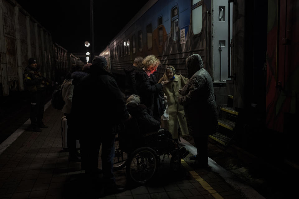 Ukrainians board the Kherson-Kyiv train at the Kherson railway station, southern Ukraine, Monday, Nov. 21, 2022. Ukrainian authorities are evacuating civilians from recently liberated sections of the Kherson and Mykolaiv regions, fearing that a lack of heat, power and water due to Russian shelling will make conditions too unlivable this winter. The move came as rolling blackouts on Monday plagued most of the country. (AP Photo/Bernat Armangue)